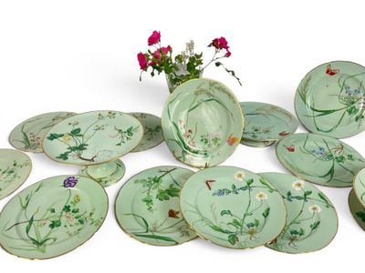 a lot of plates and vases with flowers on them
