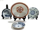 three plates with designs on them are sitting on a table