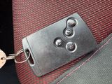a keychain that is attached to the seat belt of a car