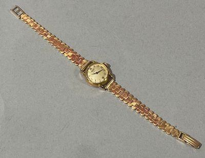 l'image d'une montre en or sur une surface blanche