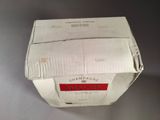 a white box with a red label sitting on a table