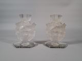 two clear glass vases sitting on top of each other