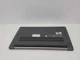 the back of a laptop computer sitting on top of a white table