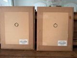 two picture frames sitting on top of a wooden table