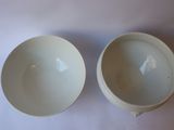 two bowls that are sitting on a table