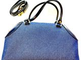 denim handbag with black leather handles and gold hardware