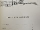 an old book with a drawing of trees and people in the distance