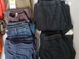 several pairs of pants are laid out on a white surface