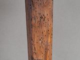 a close up of a piece of wood with holes in it