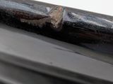 a close up of a metal object on a white surface