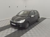 a picture of a small black car parked in a garage