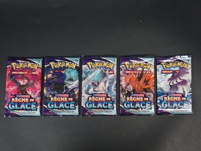 Quatre paquets de cartes du jeu de cartes à collectionner Pokémon sont alignés sur une table