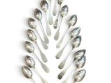 many spoons arranged in the shape of a christmas tree