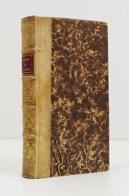 an old book sitting on top of a white table