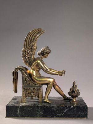 bronze statue of a woman sitting on a chair with a cat
