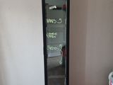 a refrigerator that has a sign on it in a room