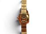 an image of a gold watch on a white surface with a white background