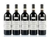 quatre bouteilles de vin sont alignées sur une surface blanche