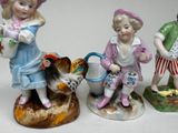 three figurines of children sitting on top of each other