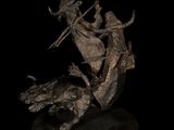 bronze sculpture of a woman riding a horse with a man on it