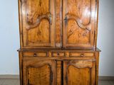 a large wooden cabinet with two doors on top of it