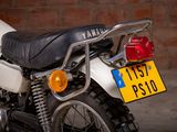 a motorcycle that is parked in front of a brick wall