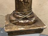 a statue of a bird on top of a pedestal