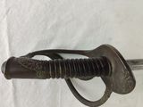 a close up of a sword on a white surface with a white background