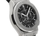 the watch is black and silver with a black leather strap