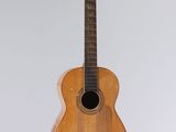 a guitar hanging from a string on the wall