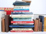 many books stacked on top of each other on a table