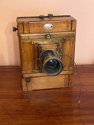 a small wooden box with a camera on top of it