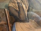 a picture of a woman sitting in a chair with her hand on her head
