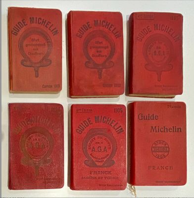 six red books are lined up in a row on a table