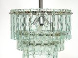 a glass chandelier hanging from the ceiling