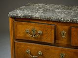 a marble top chest of drawers on display in a room