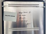 a picture of a refrigerator with a note attached to it