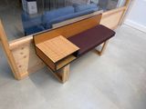 a bench and a table in front of a glass window