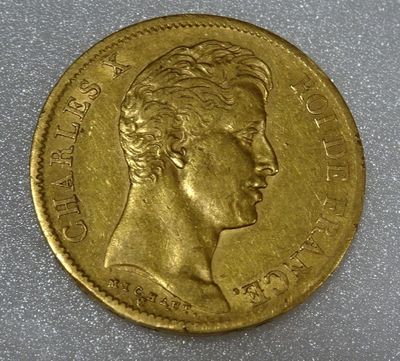 a close up of a gold coin with a woman ' s face on it