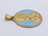 a picture of a gold and blue pendant on a white surface