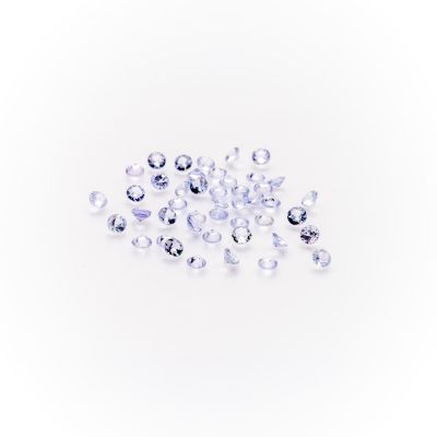 a pile of clear glass beads on a white surface