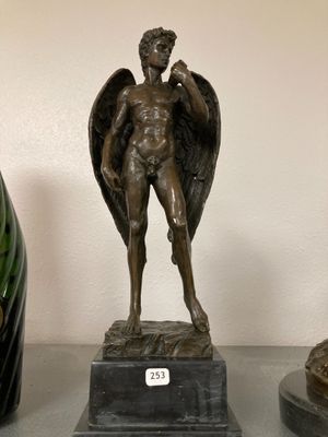 a statue of an angel on a pedestal next to two vases