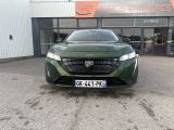 the front of a green car parked in front of a building