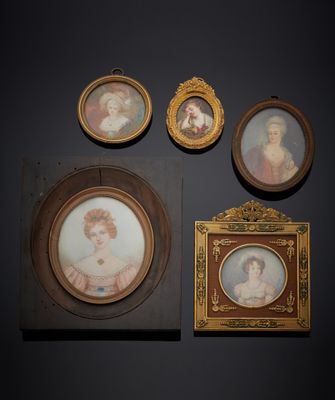 three framed portraits of women and a man are on a wall