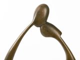 bronze sculpture of a bird on a branch on a white background