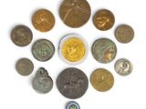 a close up of a group of coins on a white surface