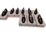 several pairs of shoes are lined up in a row on boxes