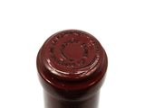 a close up of a bottle of wine on a white surface