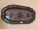 a picture of a decorative tray hanging on a wall