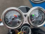 two gauges on the handlebars of a motorcycle